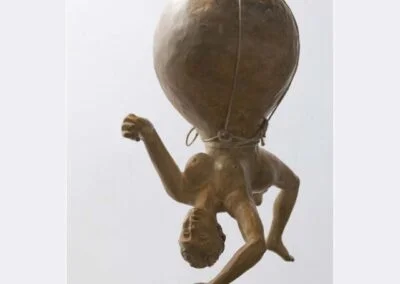 Bronze sculpture of a largely pregnant woman hanging upside down, called, Carried Away by Ellen Wetmore.