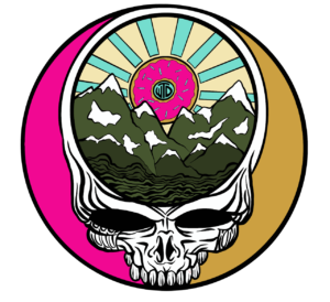 Illustrated emblem features a white skull with mountains and a rising sun inside its head. The mountains are green with white peaks, and the sun has colorful rays. The background is split with pink on the left and gold on the right.